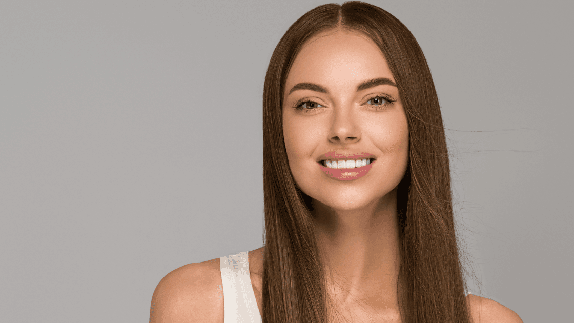 Smiling woman with sleek, straight hair after a Brazilian keratin treatment at Simon Warwick Salons, Maida Vale – smooth, frizz-free, and professionally styled.